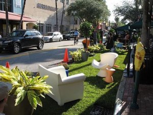 chairs sit on grass in a reclaimed parking space